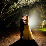 New Hall wedding bride and groom at night under arch of trees